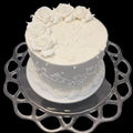Anniversary Cake, An all white cake with buttercream roses on top and scrolls on the side