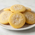 Round cookies with a sugary coating on a white surface