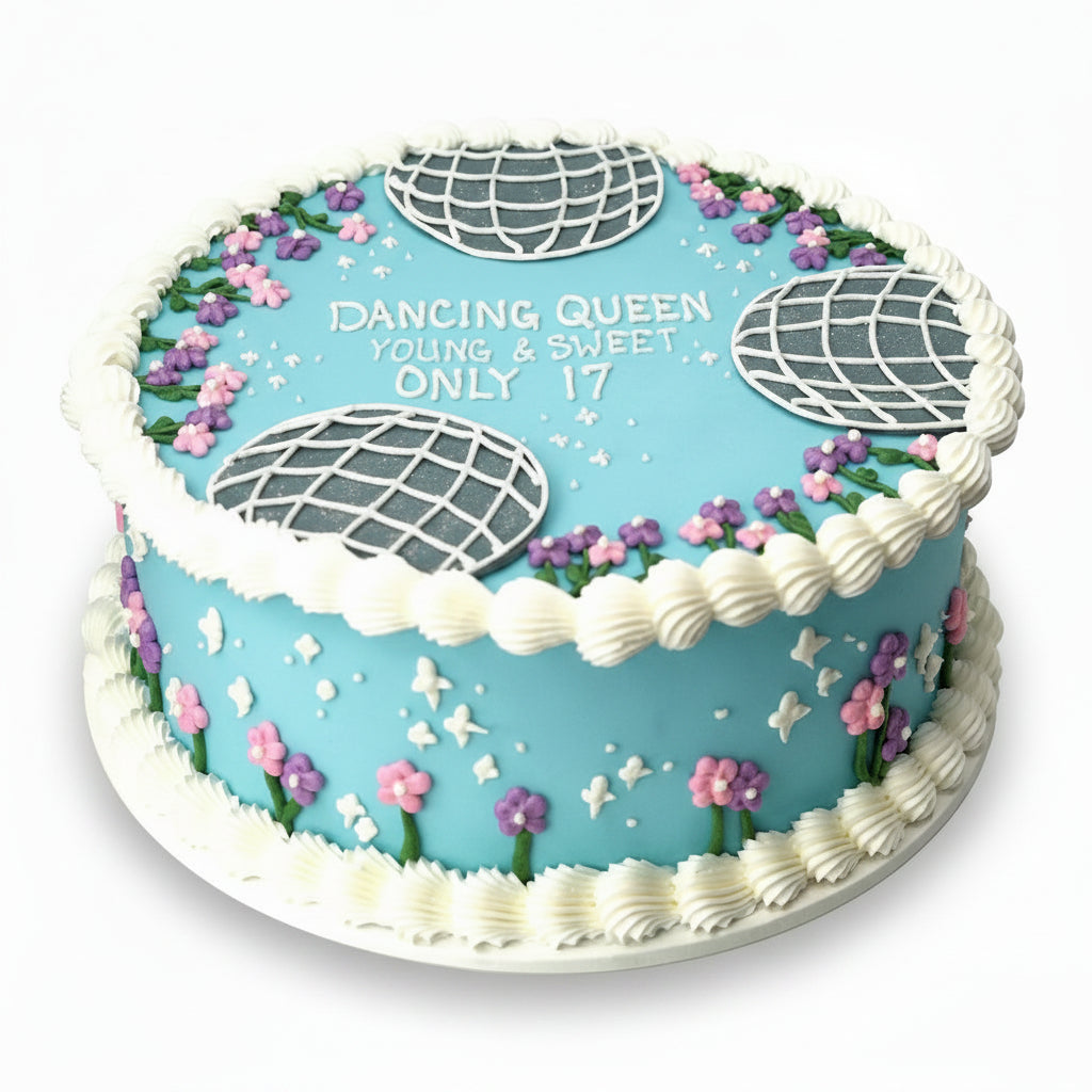 Decorative birthday cake with blue icing, white decorations, and text 'Dancing Queen Young & Sweet Only 17'.