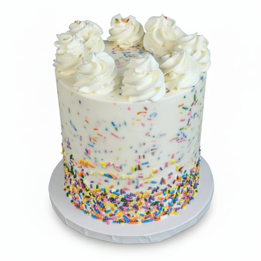 Tall cake with sprinkles in the icing and on top