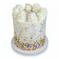 Tall cake with sprinkles in the icing and on top