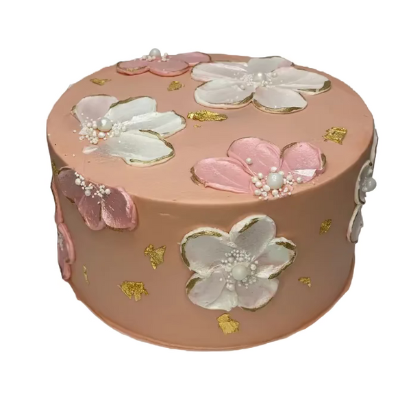 Decorative cake with floral designs on a white surface