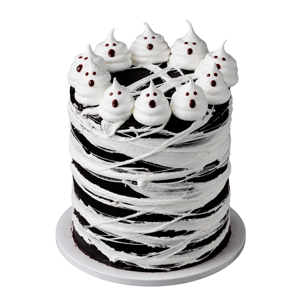 Black-and-white Halloween cake with white marshmallow webbing and playful buttercream ghost toppers, handcrafted by The Makery Cake Co in Denver.