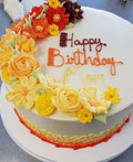Moms Birthday Cake a color full cake with an ombre flower cascade on top