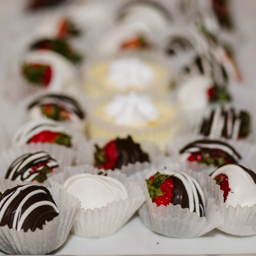 Assorted chocolate-covered treats on a white plate