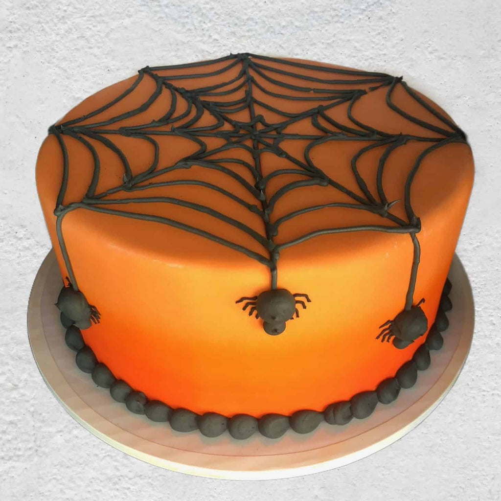 orange cake with spiders and web